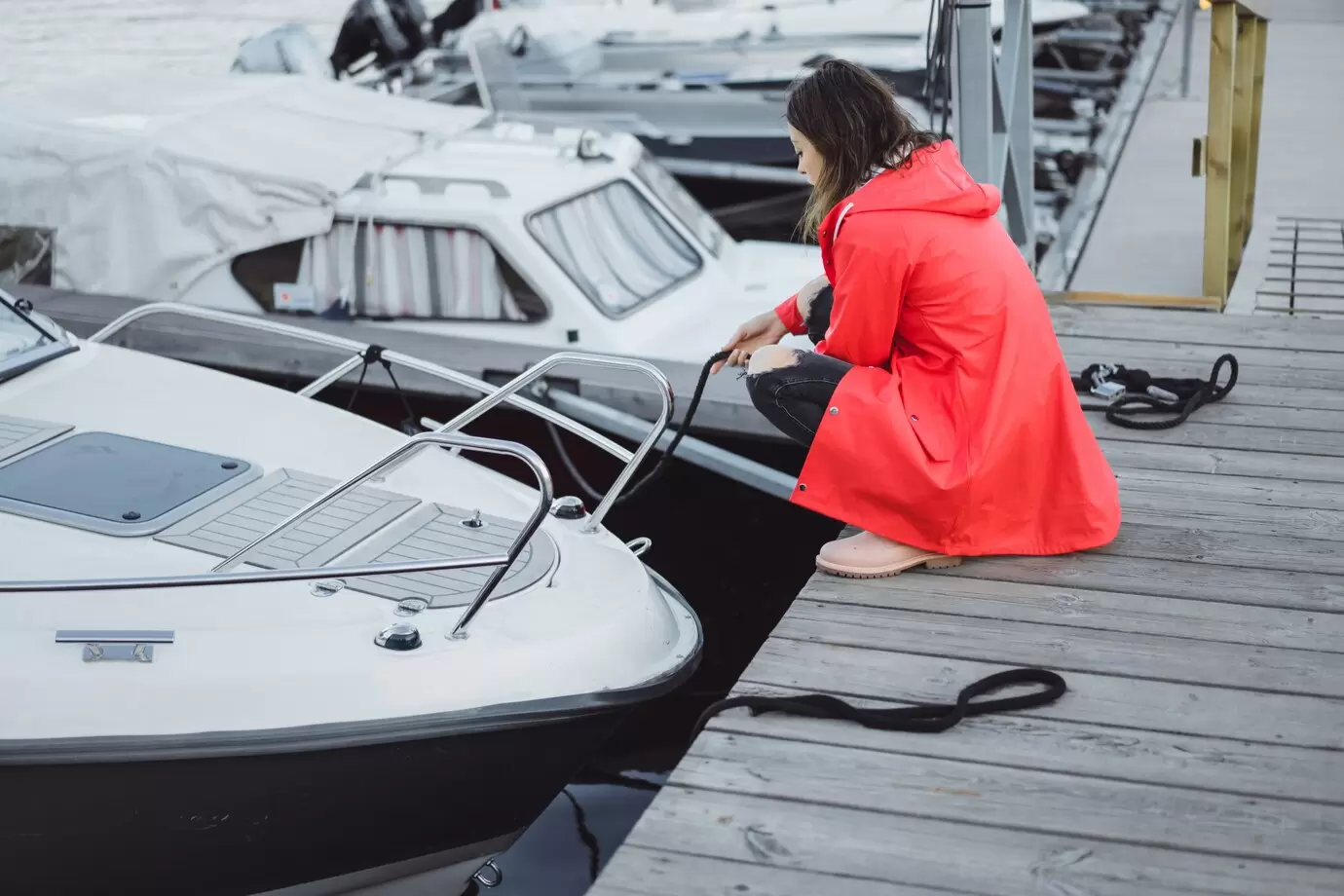 beautiful-young-woman-red-cloak-yacht-port-stockholm-sweden_72229-336