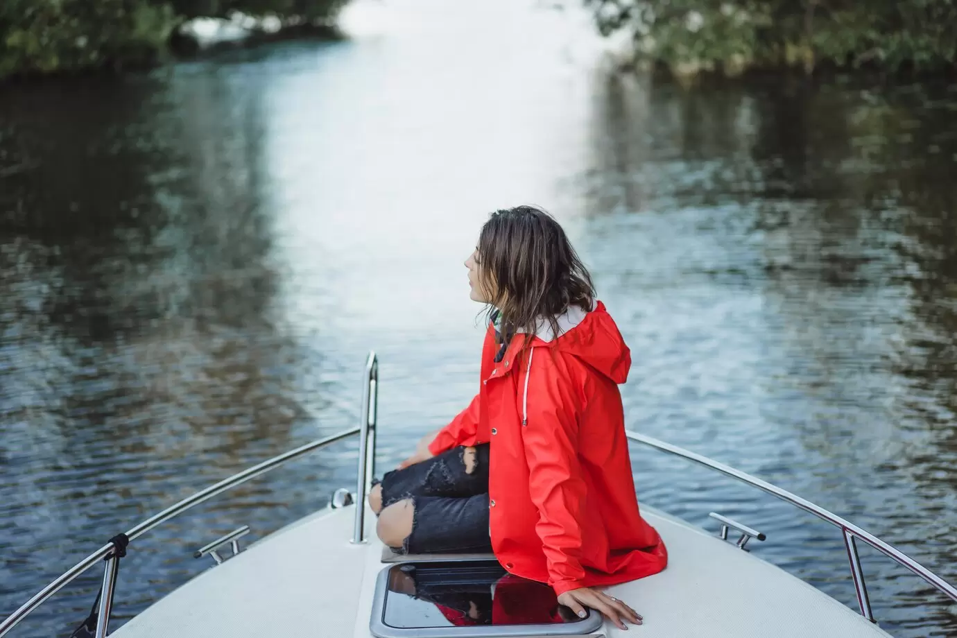 beautiful-young-woman-red-raincoat-rides-private-yacht-stockholm-sweden_72229-302